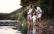 family standing at lake