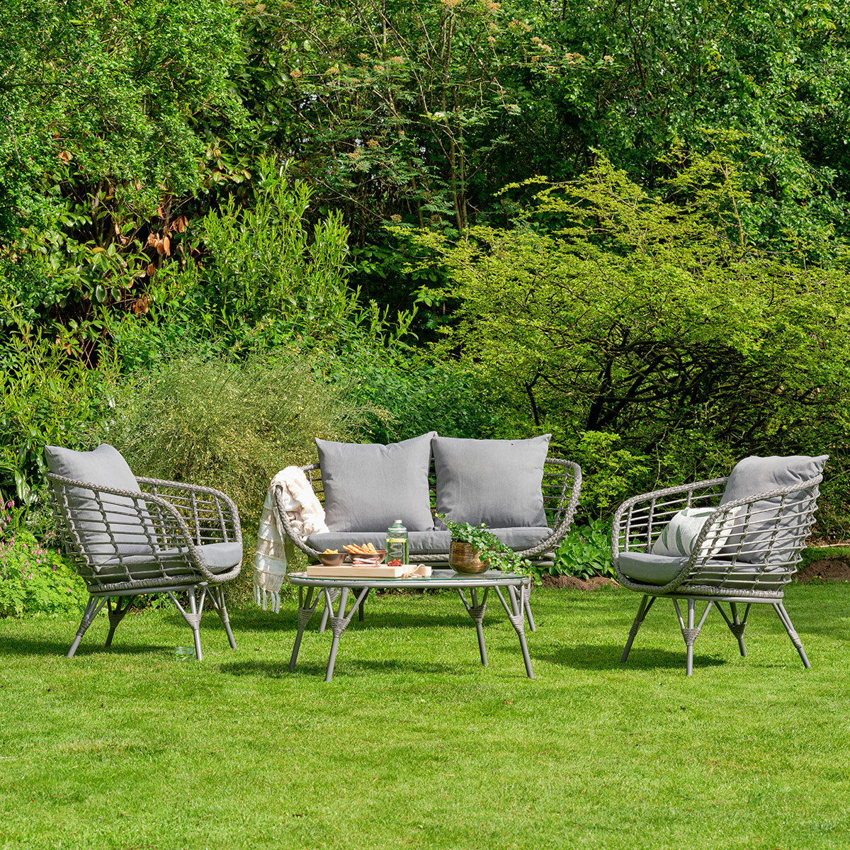 Evora 4 piece rattan wicker set on lawn