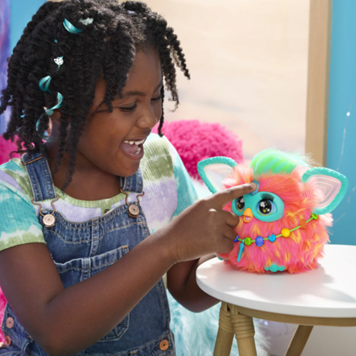Girl playing with orange Furby