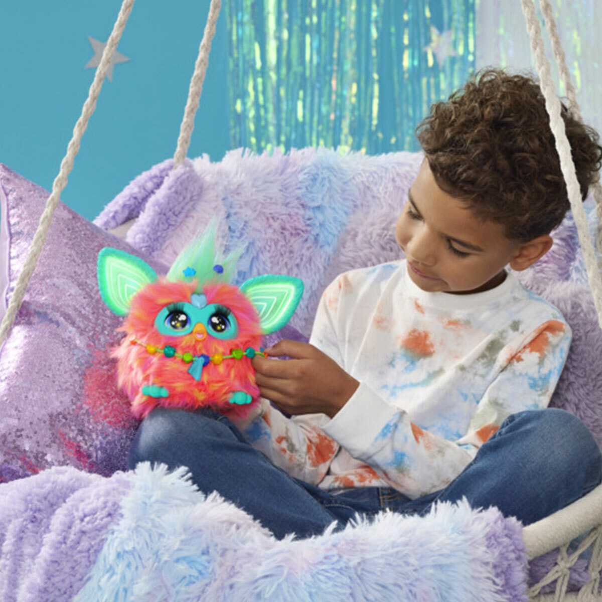 Boy playing with orange Furby