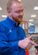 A Lewis employee shows a customer a coupon on her phone.