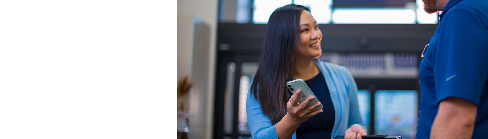 A customer shows a Lewis employee her phone.