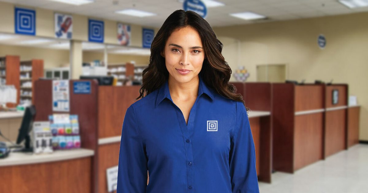 Lewis employee standing in front of the Pharmacy.