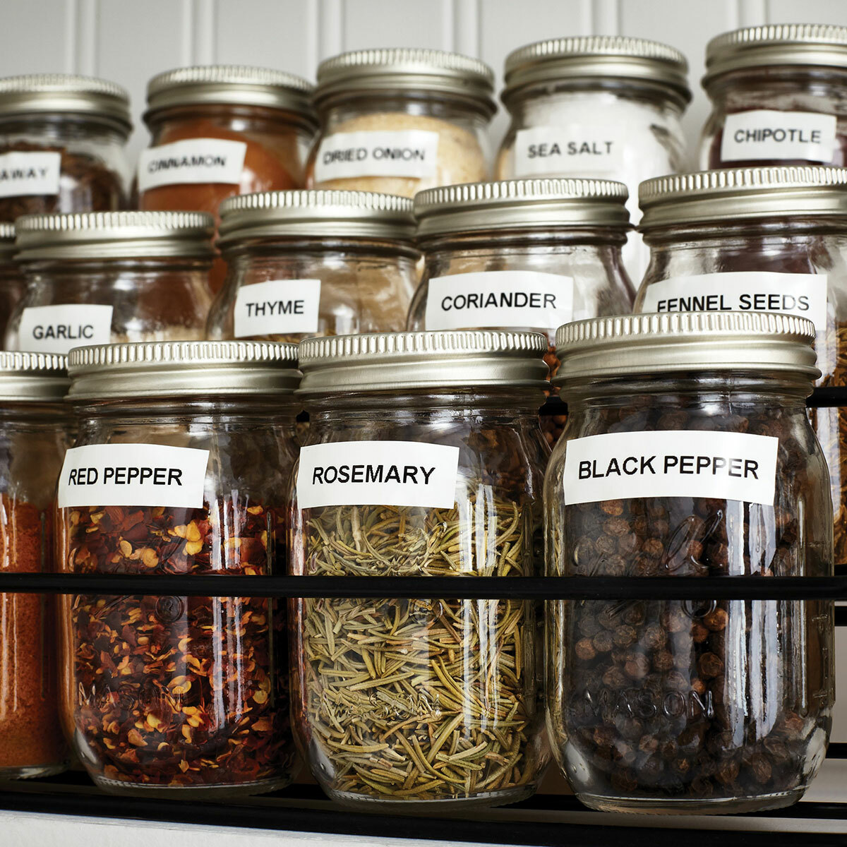 Multiple Ball mason jars labeled, in a rack