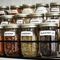 Multiple Ball mason jars labeled, in a rack