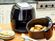 Air fryer on counter top with food in basket.