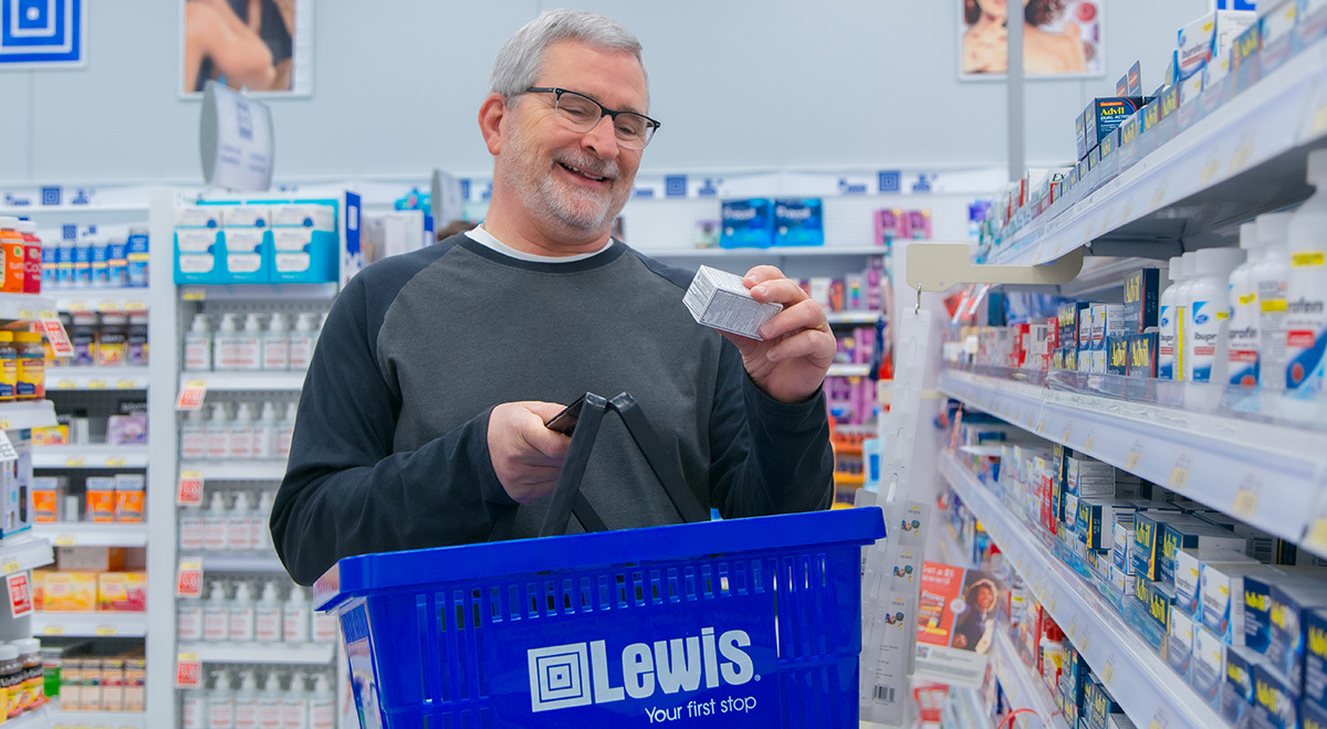 A man examines a box of medicine.